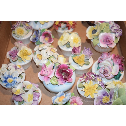 91 - A collection of ceramic flowers in baskets by Sandford and similar makers. (Qty)