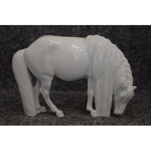 99 - Royal Copenhagen model of a grazing horse, facing right, blanc de chine, 15.5cm long.