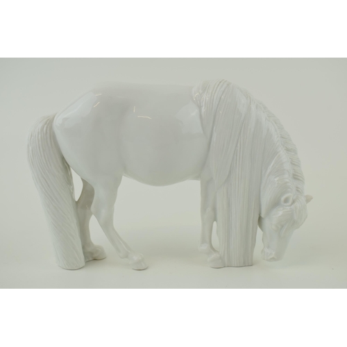 99 - Royal Copenhagen model of a grazing horse, facing right, blanc de chine, 15.5cm long.