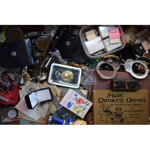 122 - A mixed collection of items to include a pair of handcuffs, pocket watches, silver chains, collectab... 