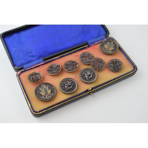 131 - A collection of vintage buttons of varying forms, to include dragons and puttis, in leather case, im... 