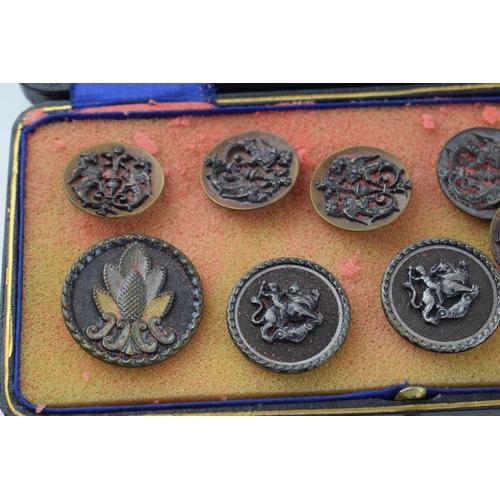 131 - A collection of vintage buttons of varying forms, to include dragons and puttis, in leather case, im... 