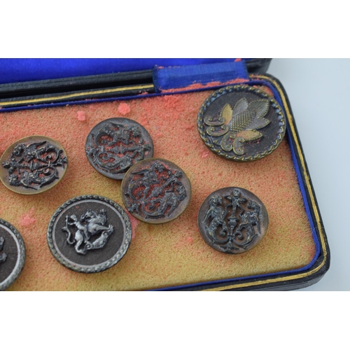 131 - A collection of vintage buttons of varying forms, to include dragons and puttis, in leather case, im... 