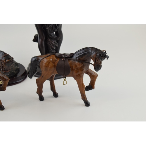 4 - A collection of decorative items to include bronzed resin figures and leather horses. (4)