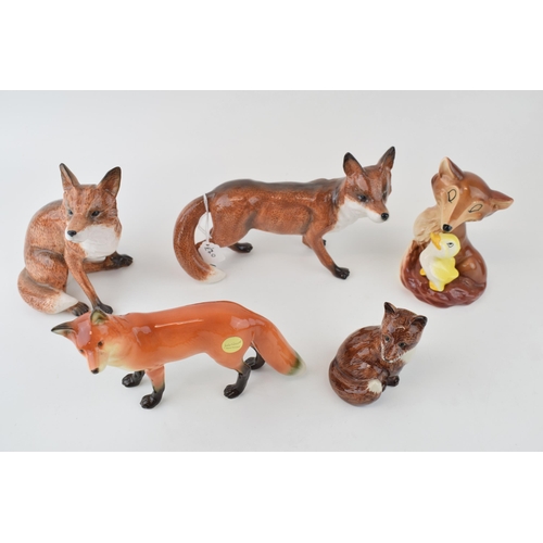 53 - A collection of pottery fox figures to include a modern John Beswick example, a Hornsea fox with duc... 