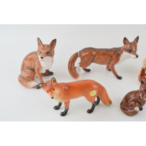 53 - A collection of pottery fox figures to include a modern John Beswick example, a Hornsea fox with duc... 