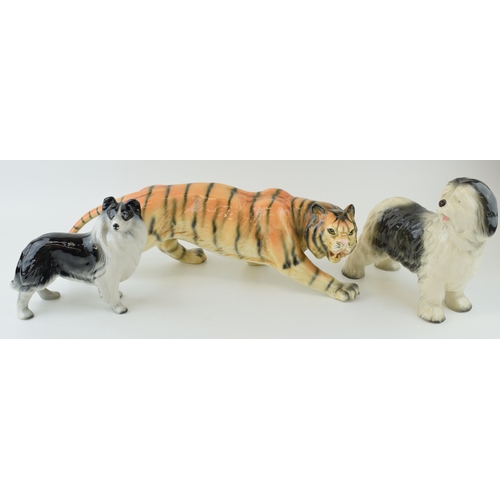 56 - Melba Ware pottery animals to include a large stalking tiger and two dogs, longest 41cm long (3).