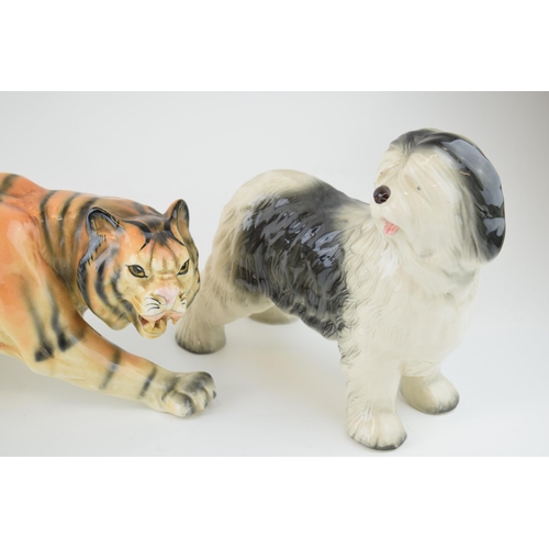 56 - Melba Ware pottery animals to include a large stalking tiger and two dogs, longest 41cm long (3).