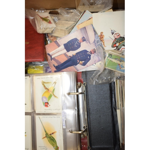 76 - A large quantity of mixed cigarette cards, postcards and Brooke Bond Tea albums. (Qty)