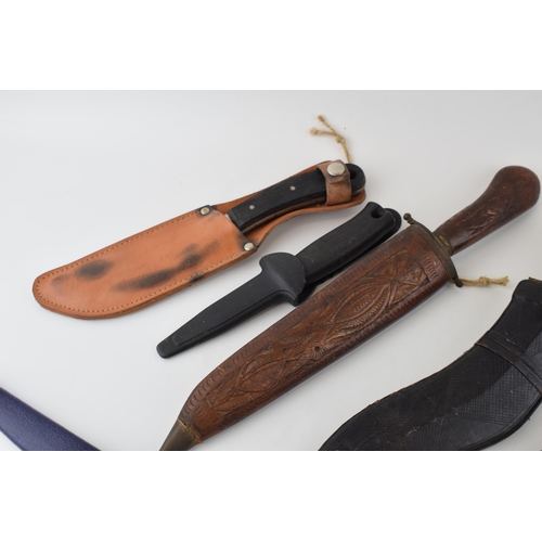 84 - A collection of vintage knives to include sheath knives, hunting knives and Gurkha style Kukhri kniv... 