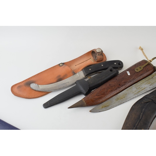 84 - A collection of vintage knives to include sheath knives, hunting knives and Gurkha style Kukhri kniv... 