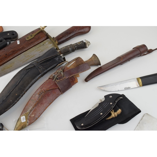 84 - A collection of vintage knives to include sheath knives, hunting knives and Gurkha style Kukhri kniv... 