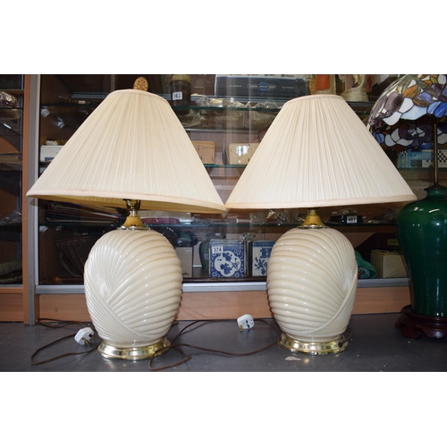 134 - A pair of mid to late 20th century Art Deco style glass lamp bases, ribbed design, with shades, 74cm... 