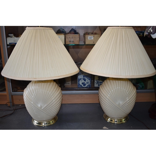 134 - A pair of mid to late 20th century Art Deco style glass lamp bases, ribbed design, with shades, 74cm... 