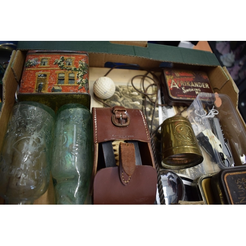 164 - A mixed collection of items to include vintage advertising tins, Puch and GB automobilia stickers, a... 