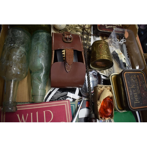 164 - A mixed collection of items to include vintage advertising tins, Puch and GB automobilia stickers, a... 