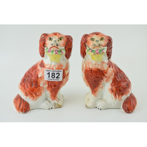 182 - A pair of Staffordshire dogs, with baskets of flowers in mouths, 16cm tall (2).