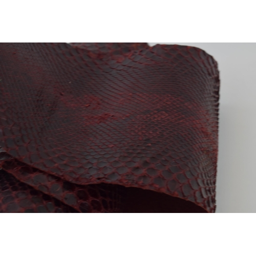 203 - A snake skin dyed maroon suitable for crafting or leatherwork. Section has been cut out. Length 267c... 