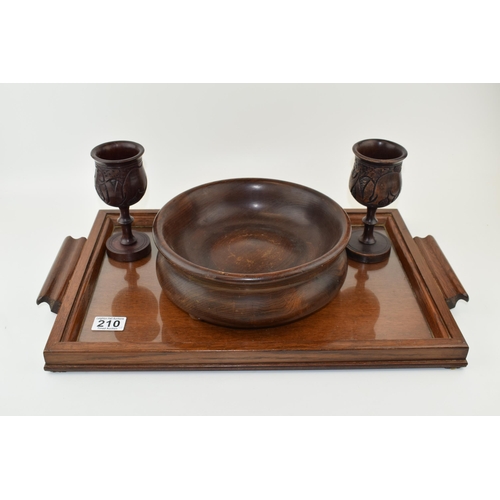 210 - A wooden butlers tray with glass liner, a turned wooden fruit bowl with a near pair of carved goblet... 