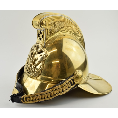 224 - Large brass fireman's helmet, crest to front, with chin strap, 37cm long.