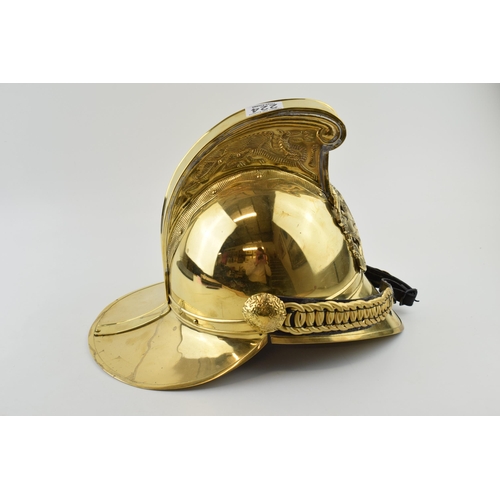 224 - Large brass fireman's helmet, crest to front, with chin strap, 37cm long.