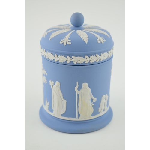 239 - Wedgwood Blue Jasperware lidded jar with traditional relief, 11.5cm tall.