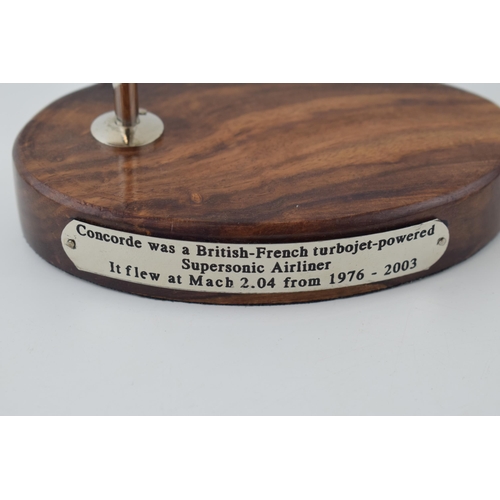 245 - Reproduction model of Concorde, wooden base, engraved plaque, 18.5cm tall.