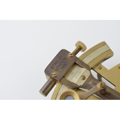 282 - A replica sextant in brass with wooden handle. Marked Stanley London 1880. 12cm.