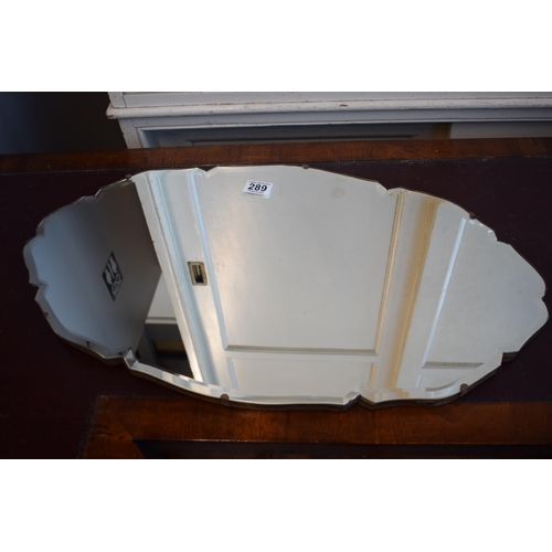 289 - A Mid-Century bevelled edge glass mirror 68cm x 39cm.