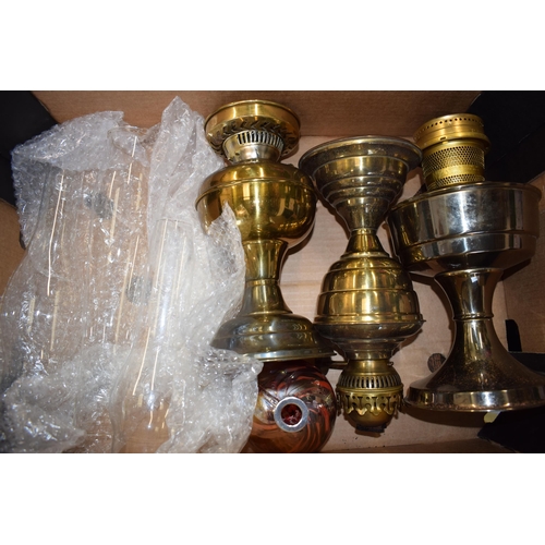 302 - A trio of brass oil lamps complete with shades. (3)