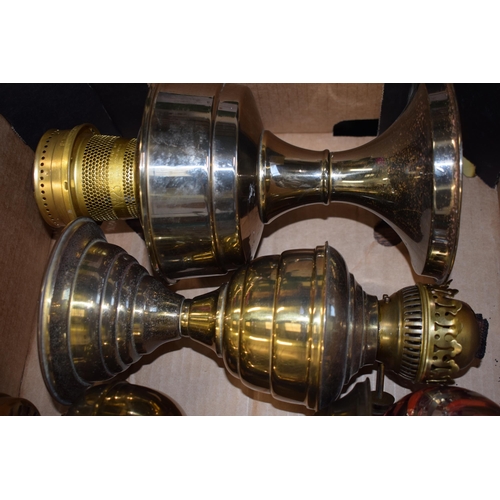 302 - A trio of brass oil lamps complete with shades. (3)