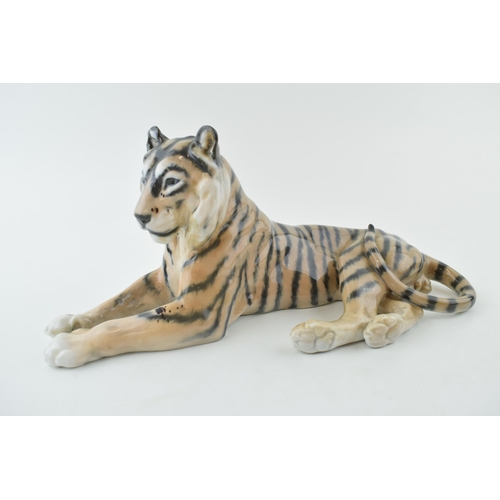 106 - Royal Copenhagen figure of a recumbent tiger, 31cm wide, chipped ear.