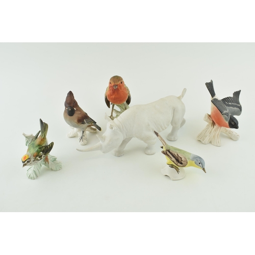 107 - Goebel pottery to include a matte white rhino and five birds (6).