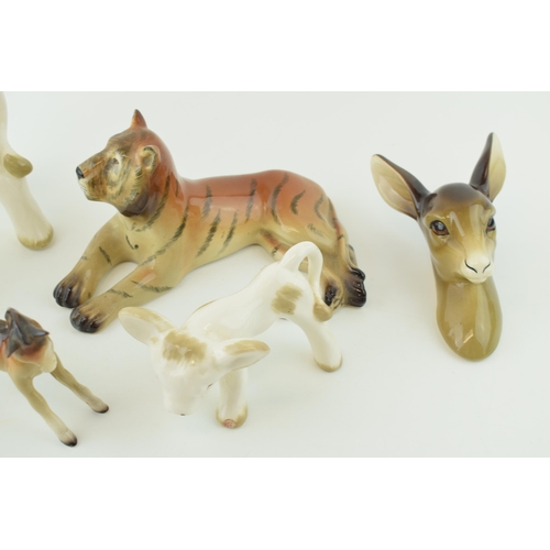 124 - A collection of Midwinter pottery figures to include a foal, a deer wall hanging, a tiger and a styl... 