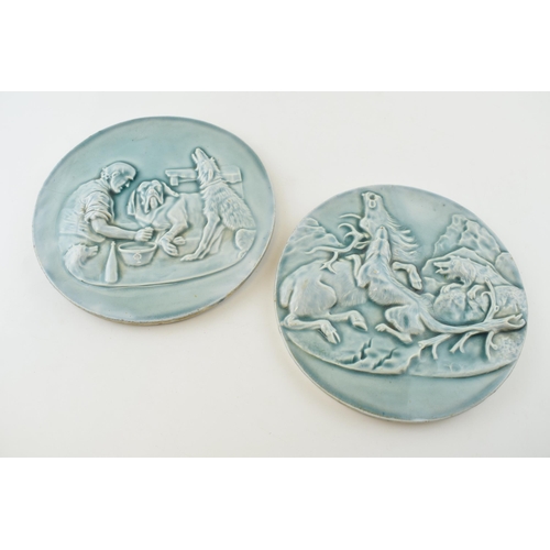 144 - Early to mid 20th century glazed roundel plaques, embossed decoration, one with a dog hunting stag s... 