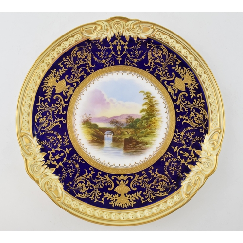 146 - Coalport gilded cabinet plate 'Ambleside' with jeweled gilded decoration, 23cm diameter.