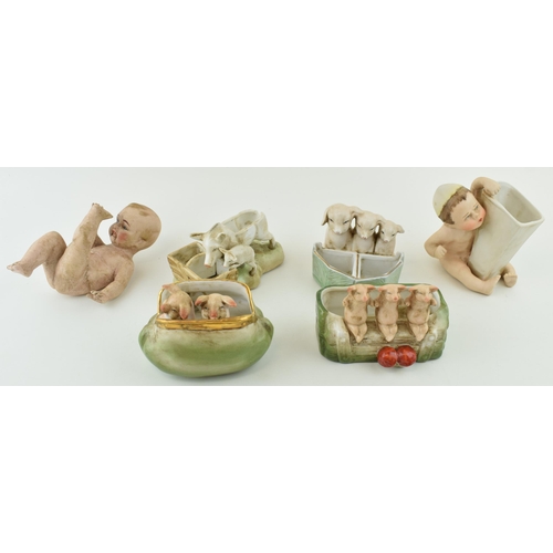 155 - A collection of German Bisque pottery to include pig fairings and two children (6).