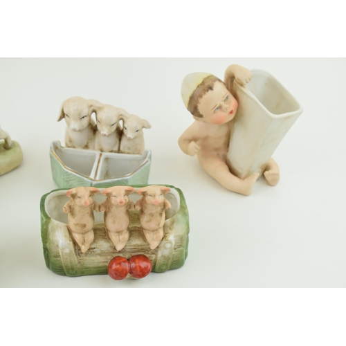 155 - A collection of German Bisque pottery to include pig fairings and two children (6).