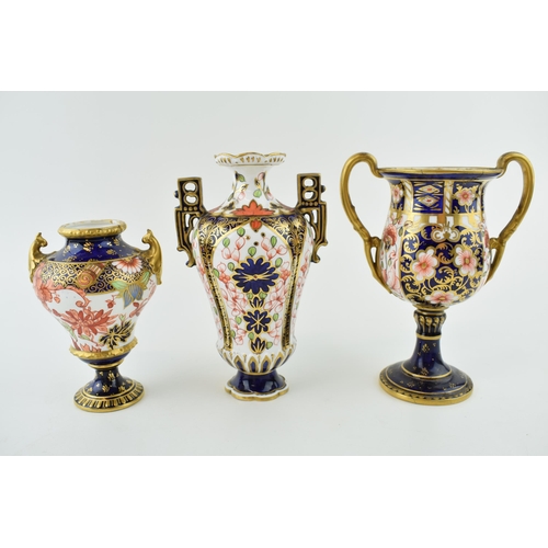 162 - Royal Crown Derby imari pottery to include a double handled trophy cup, 16cm tall, a two handled vas... 