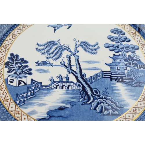 178 - A pair of Royal Doulton Booths Willow Pattern Ware 'Real Old Willow' trial plates / chargers with fr... 