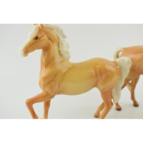 53 - Two Beswick palomino horses to include a prancing arab and a mare facing right (2 - both restored).