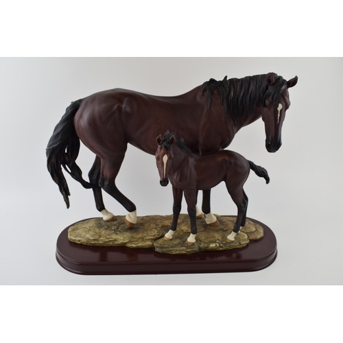 57 - The Leonardo Collection horse and foal tableau, wooden base, 44cm wide.