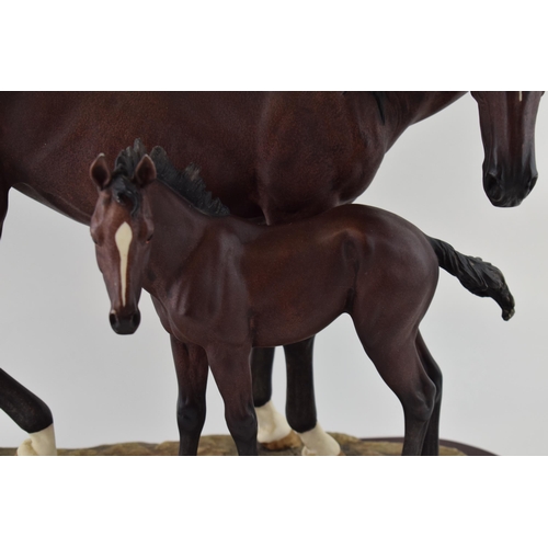 57 - The Leonardo Collection horse and foal tableau, wooden base, 44cm wide.