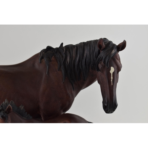 57 - The Leonardo Collection horse and foal tableau, wooden base, 44cm wide.