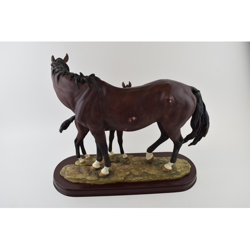 57 - The Leonardo Collection horse and foal tableau, wooden base, 44cm wide.