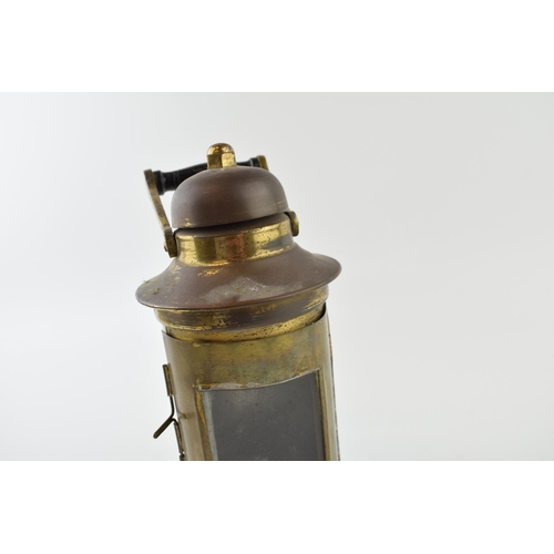 356 - A brass ships Binnacle oil lamp with burner dated 1943 L.S. Co Ltd. Height 26cm.