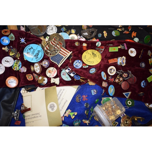 448 - A collection of enamel badges and pin badges, cap badges and belt buckles. (Qty)