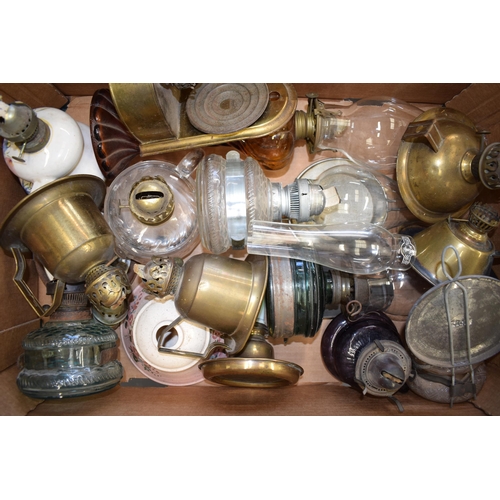 460 - A mixed collection of vintage and antique tin, pottery and brass oil lamps with glass chimneys and p... 