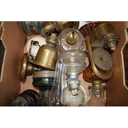 460 - A mixed collection of vintage and antique tin, pottery and brass oil lamps with glass chimneys and p... 