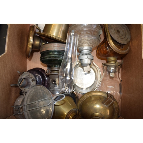 460 - A mixed collection of vintage and antique tin, pottery and brass oil lamps with glass chimneys and p... 